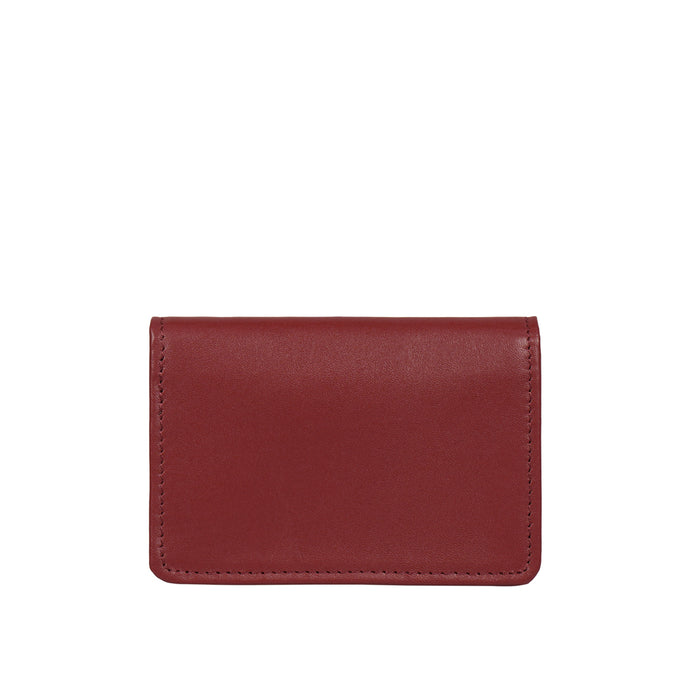 Minimal red leather card holder with smooth and clean stitching, designed for compact everyday use.