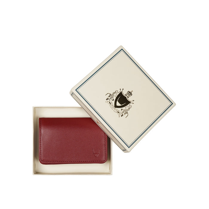 Hidesign red leather card holder placed in premium gift box packaging, compact design, smooth finish