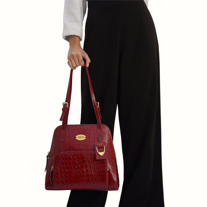 Woman holding Hidesign Marsala crocodile-textured leather tote bag with a structured shape & straps.