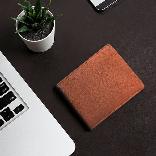 Minimalist tan bi-fold wallet for men, crafted from fine EI goat leather with subtle edge stitching.