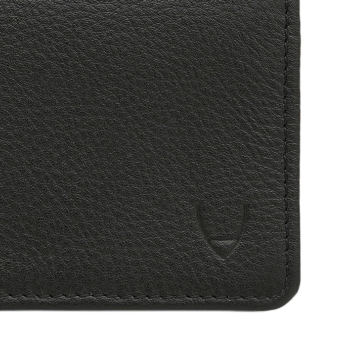 Close-up of black leather card holder by Hidesign showing fine grain texture, neat stitching & logo.