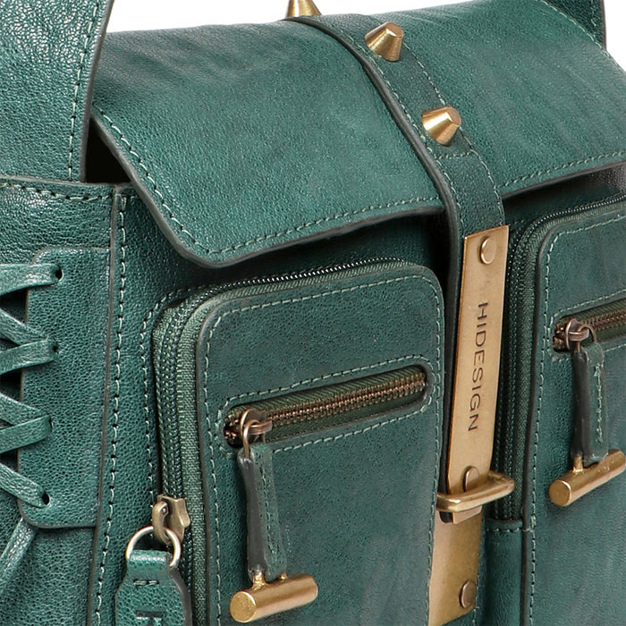 Close-up of green leather shoulder bag showing front zip pockets, studs, and Hidesign clasp.