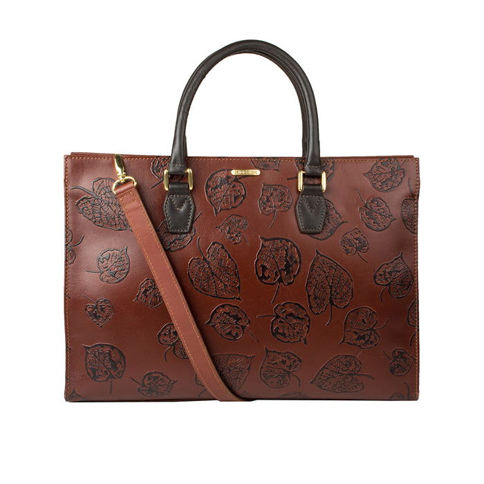 Kester women's brown leather laptop bag with black leaf embossing, top handles, & detachable strap.