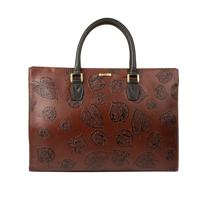 Front view of Hidesign Kester women's brown leather laptop bag with black leaf embossing & handles.
